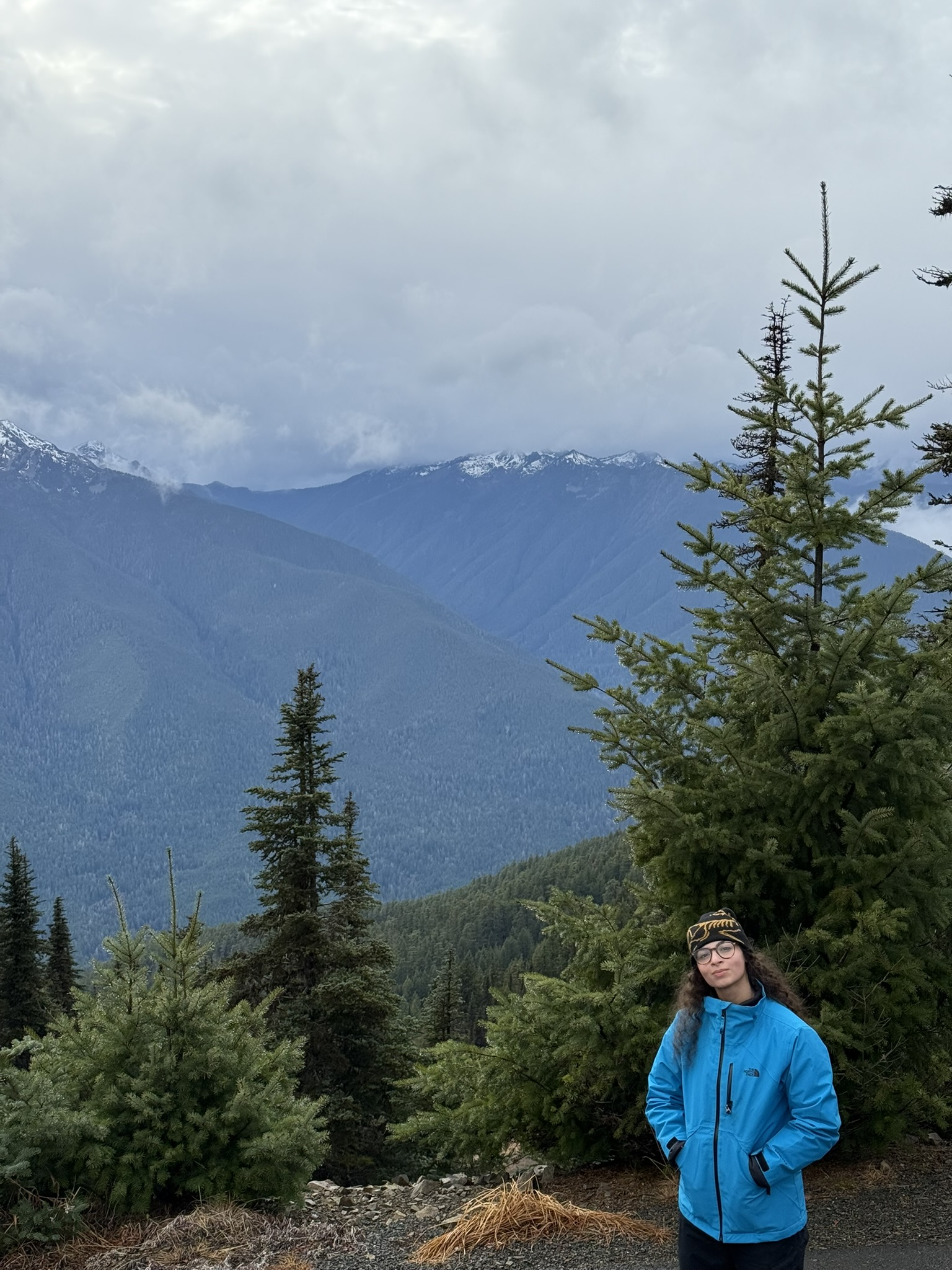 Carinne standing before a mountain landscape